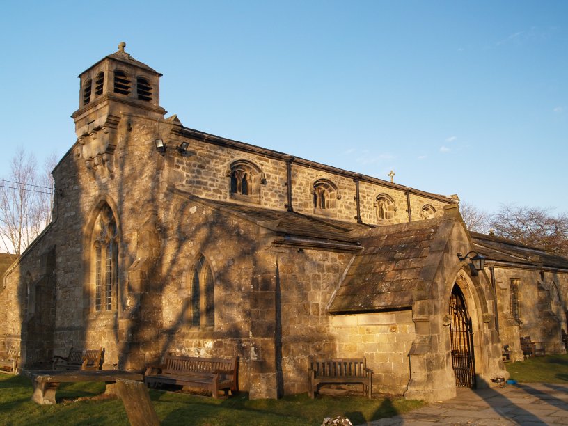 Parish Church of St Michael and All Angels north-east of Linton village on the banks of the River Wharfe dates from ~1150 and retains some original Norman architectural features. The squat square bell tower might date from the 13th century walk from Grassington, Wharfedale, North Yorkshire Dales National Park, England