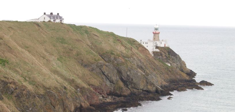 The sturdy Bailey Lighthouse on the headland overlooking Dublin Bay Howth to Sutton Cliff Walk, Co. Dubin, Ireland