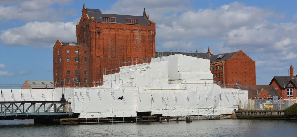 Work in progress by the Corporation Bridge and beyond the Alexandra Dock, the great brick building of the Victoria Mill, Grimsby