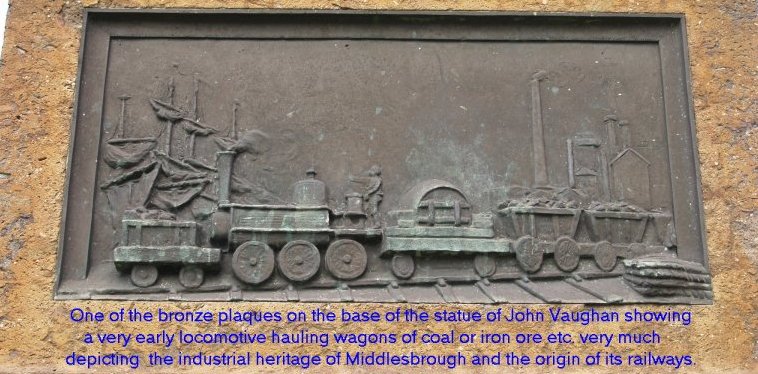 Location 00c: One of the bronze plaques on the base of the statue of John Vaughan (1799-1868) in the Town Hall Square shows a sailing ship, iron works and a very early locomotive hauling wagons of coal or iron ore etc. very much depicting the industrial heritage of Middlesbrough and the origin of its railways.