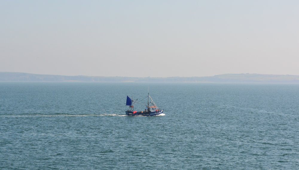 A small fishing boat leaving Dunmore East Harbour, Co. Waterford, Ireland
