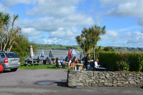 outside garden tables overlook the estuary of Travara Lodge eating Courtmacsherry, Co. Cork, West of Ireland