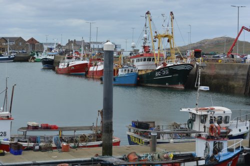 Fishing vessels in Howth Harbour - Trawler SC-35 Jacob Senior, behind it the smaller blue blue fishing boat Paddy Rose Howth harbour, Co. Dublin, Ireland