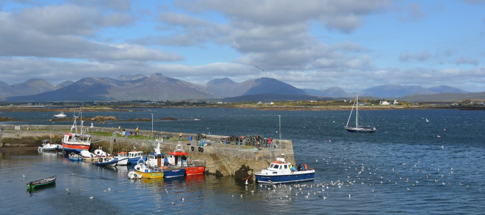 Looking across the idyllic Roundstone Harbour towards the Twelve Bens of Connemara Roundstone, Connemara, Co. Galway, Ireland