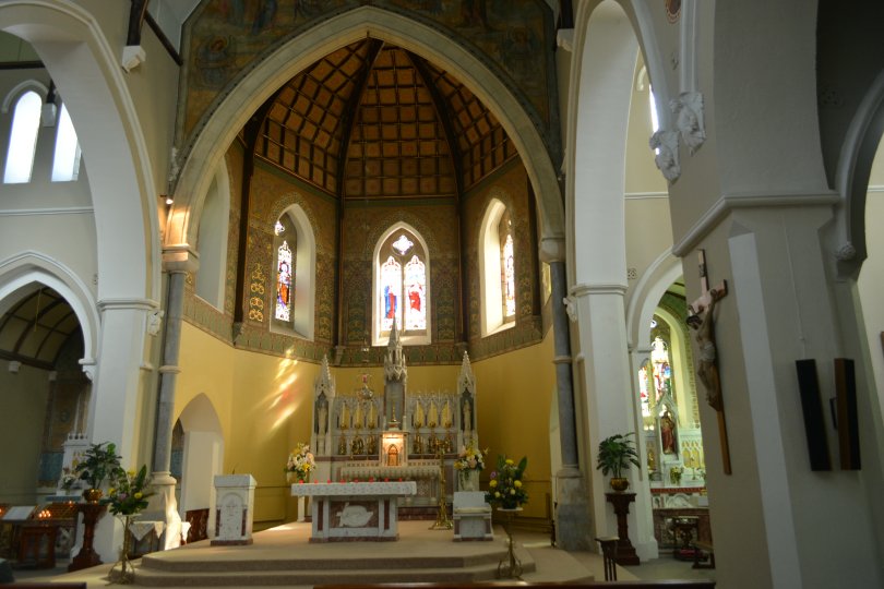 The altar and stained glass windows above the reredos of St Joseph's Church, Clifden, Connemara, Co. Galway, Ireland