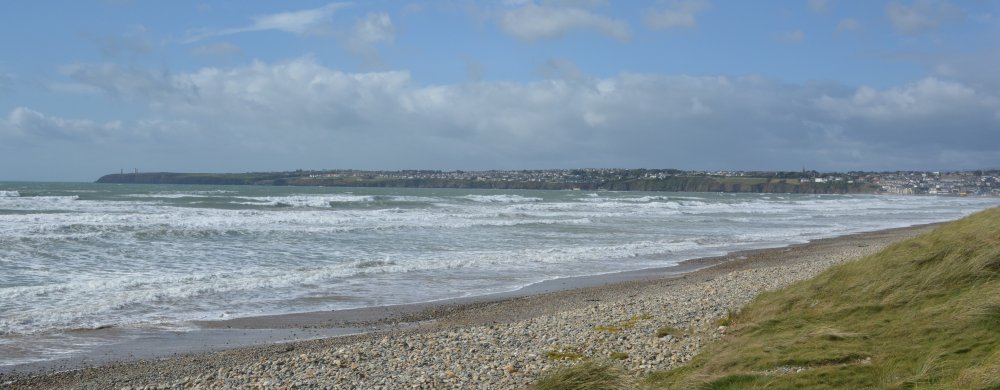 the constant 'rough' wave action crashing on the beach of Tramore Strand, Co. Waterford, Ireland