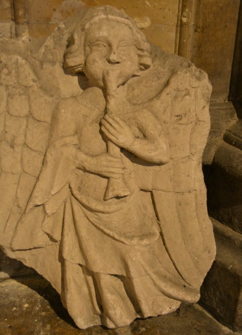 Sculpture of an angel playing the shawm Tewkesbury Abbey Gloucestershire England
