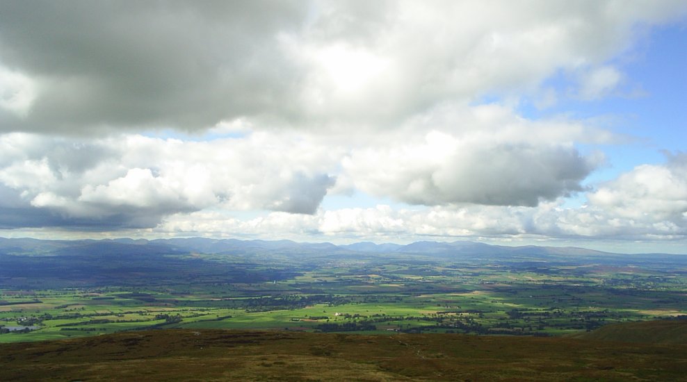 27. Looking across the Eden Valley, a view of the Lake District Hills-Fells-Mountains from the summit of Crossfell in East Cumbria. Cross Fell is the highest point in the Pennines.