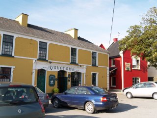 Vaughan's pub-bar provides good food and traditional Irish Music in the village of Kilfenora, The Burren, County Clare, Ireland. Next to it is an independent hostel for budget accommodation (red building).