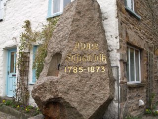 The memorial to great pioneering geologist Adam Sedgwick 1785-1873 in Main Street - Dent Village, Yorkshire Dales, Cumbria, England