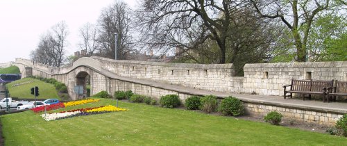 The City Walls across the Lendal Bridge on the road to the station, punctuated twice by the busy road.