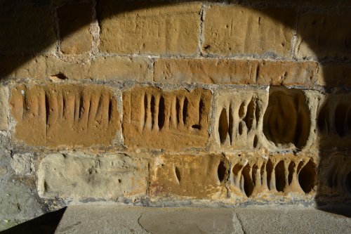 sharpening arrow heads deep grooved carvings in porch of St Mary's Church, Thirsk, purpose?
