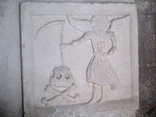 interesting and unusual gravestone/tombstone in the north wall of the north aisle of Peterborough Cathedral
