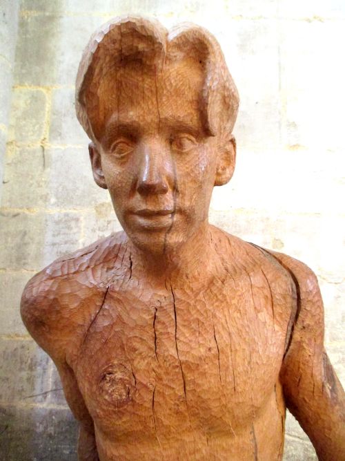 details of carved wooden statue of St Peter leaves the boat to meet Jesus sculpture Simon Lathern