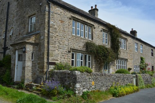 Attractive stone holiday cottages and private houses in Buckden village Linear walk up Buckden Pike, Yorkshire Dales National Park, North Yorkshire