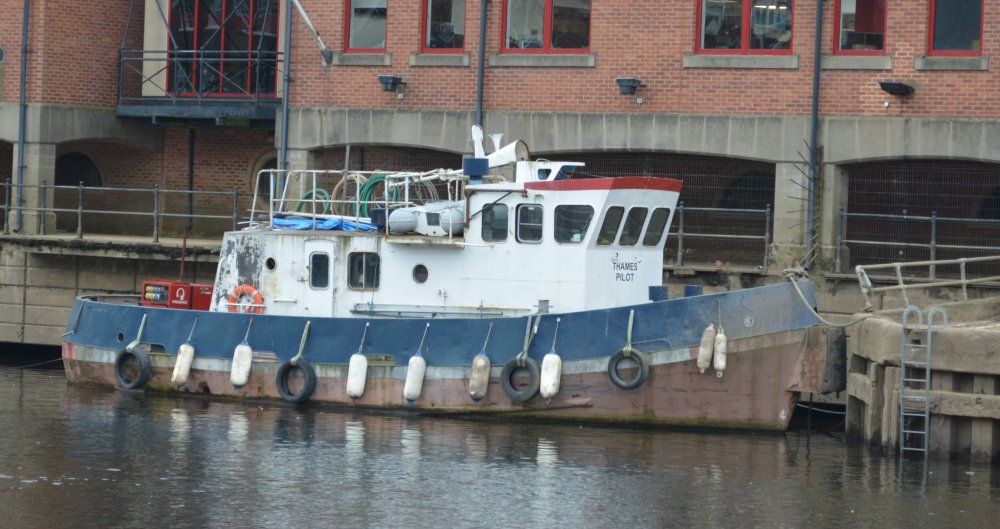 An old Thames Pilot vessel moored on the River Ouse near the Ouse Bridge, York, England