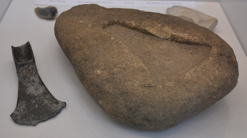 A bronze age axe and stone carved mould for casting the metal (Dales Countryside Museum, Hawes)