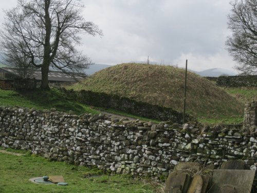 A Norman Motte (defended round hill) in a farmyard off the main street through  Circular walk from Carlton in Coverdale