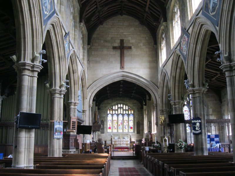 Looking east through the nave to the chancel, altar and east window of St Mary's Parish Church, Thisk, North Yorkshire, England