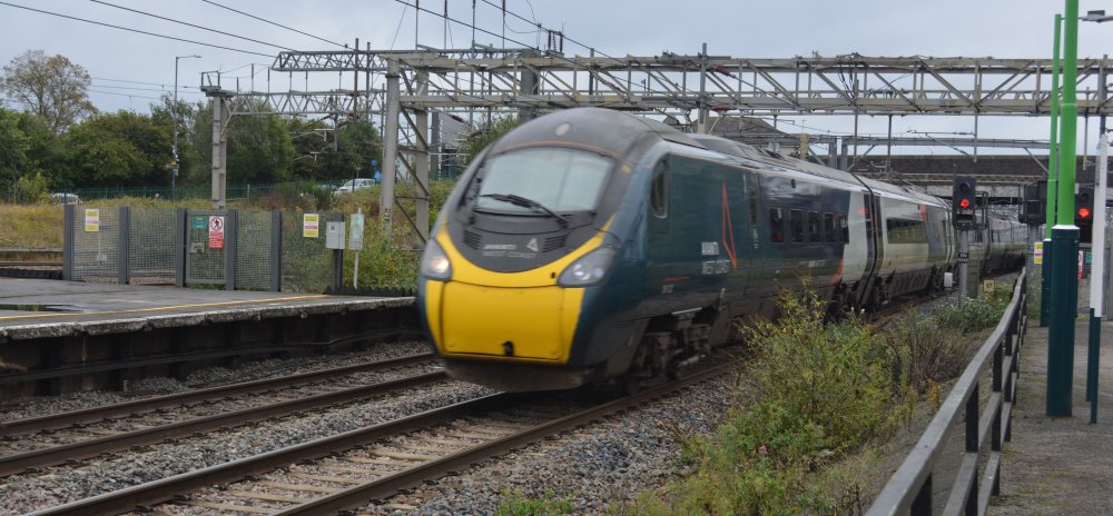 Class 390 EMU heading north at high speed through Nuneaton station, 2024